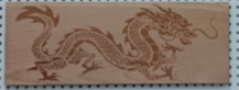 Shallow engraved dragon on cherry wood. Shallow engraved dragon on cherry wood.