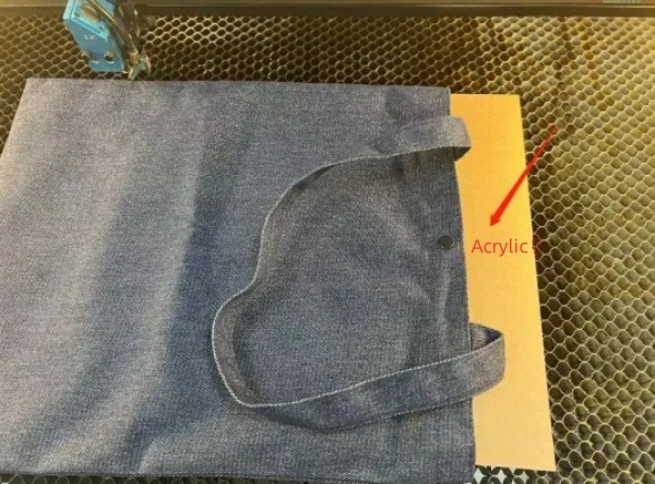 1779785393560703.jpeg Acrylic backing inside fabric bag for laser processing