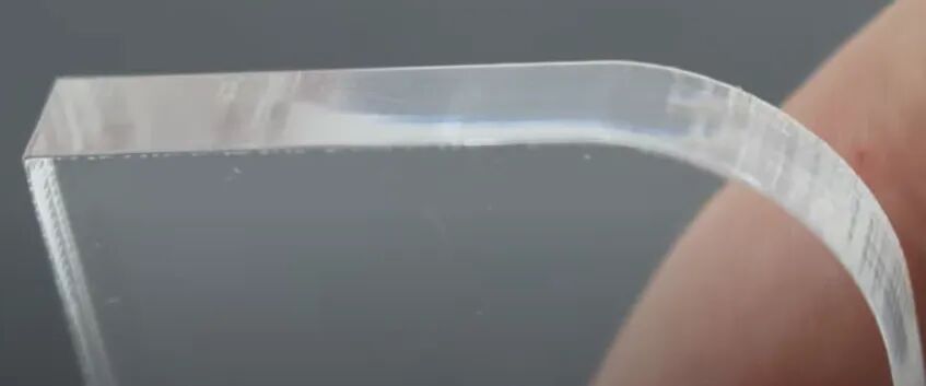 1779786542950094.jpeg Acrylic edge with visible vertical striations after laser cutting