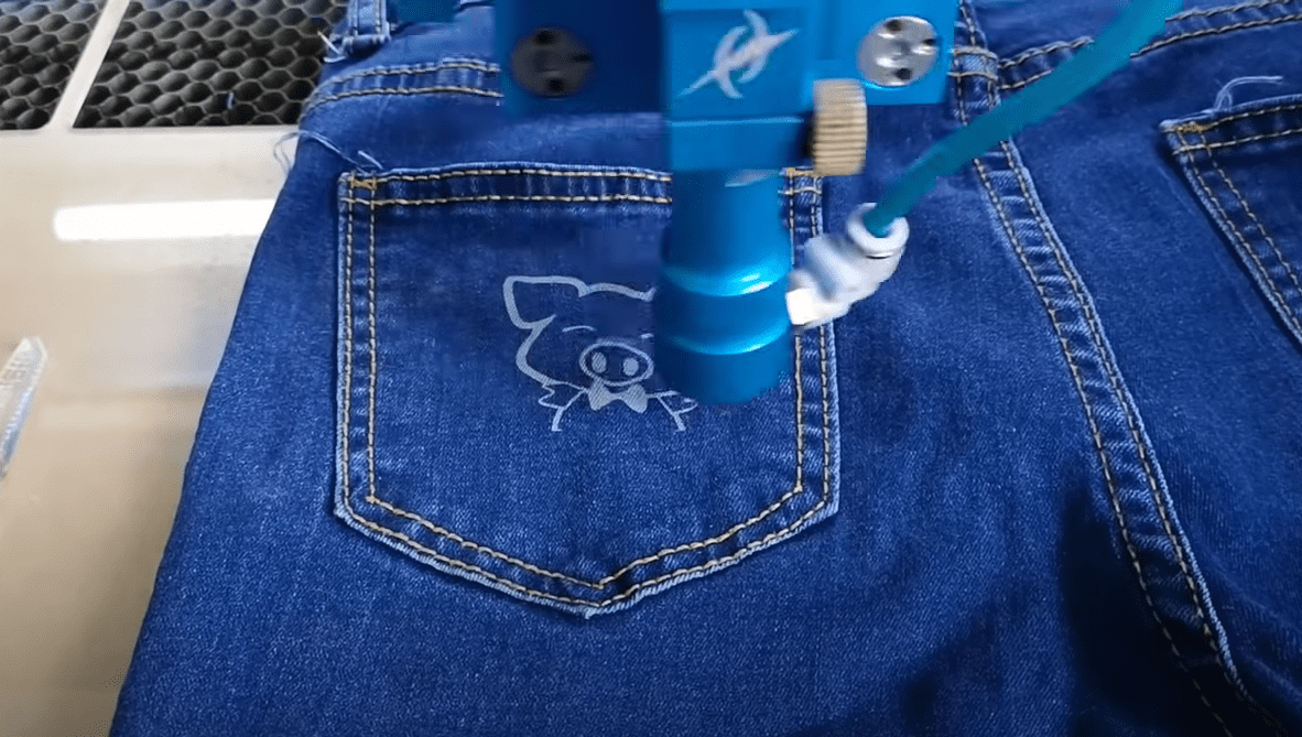 Laser etched jeans with custom decorative pattern