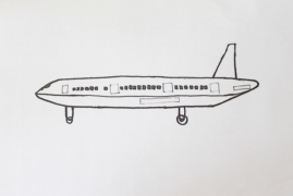 Hand drawing an airliner side view on paper