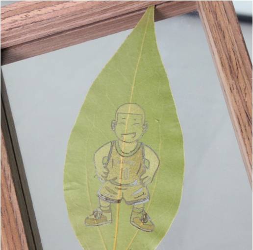 Finished laser engraved leaf art displayed in a frame