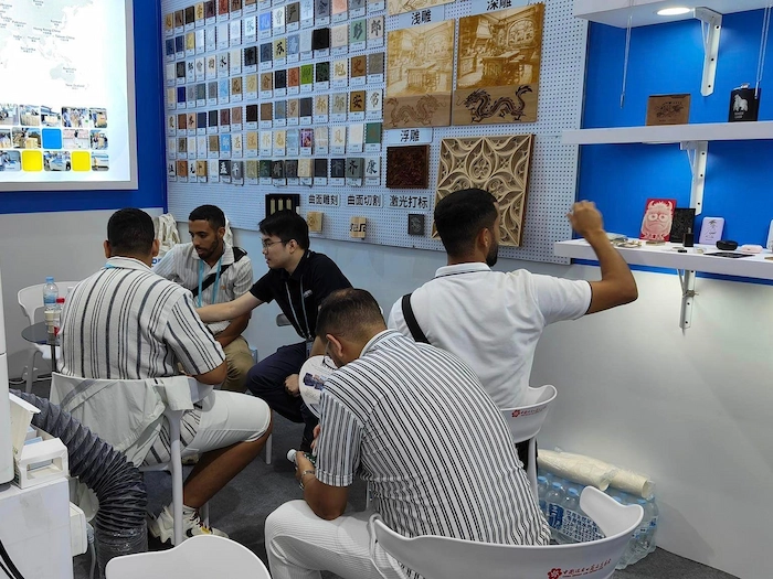 Thunder Laser team discussing laser applications with Canton Fair visitors