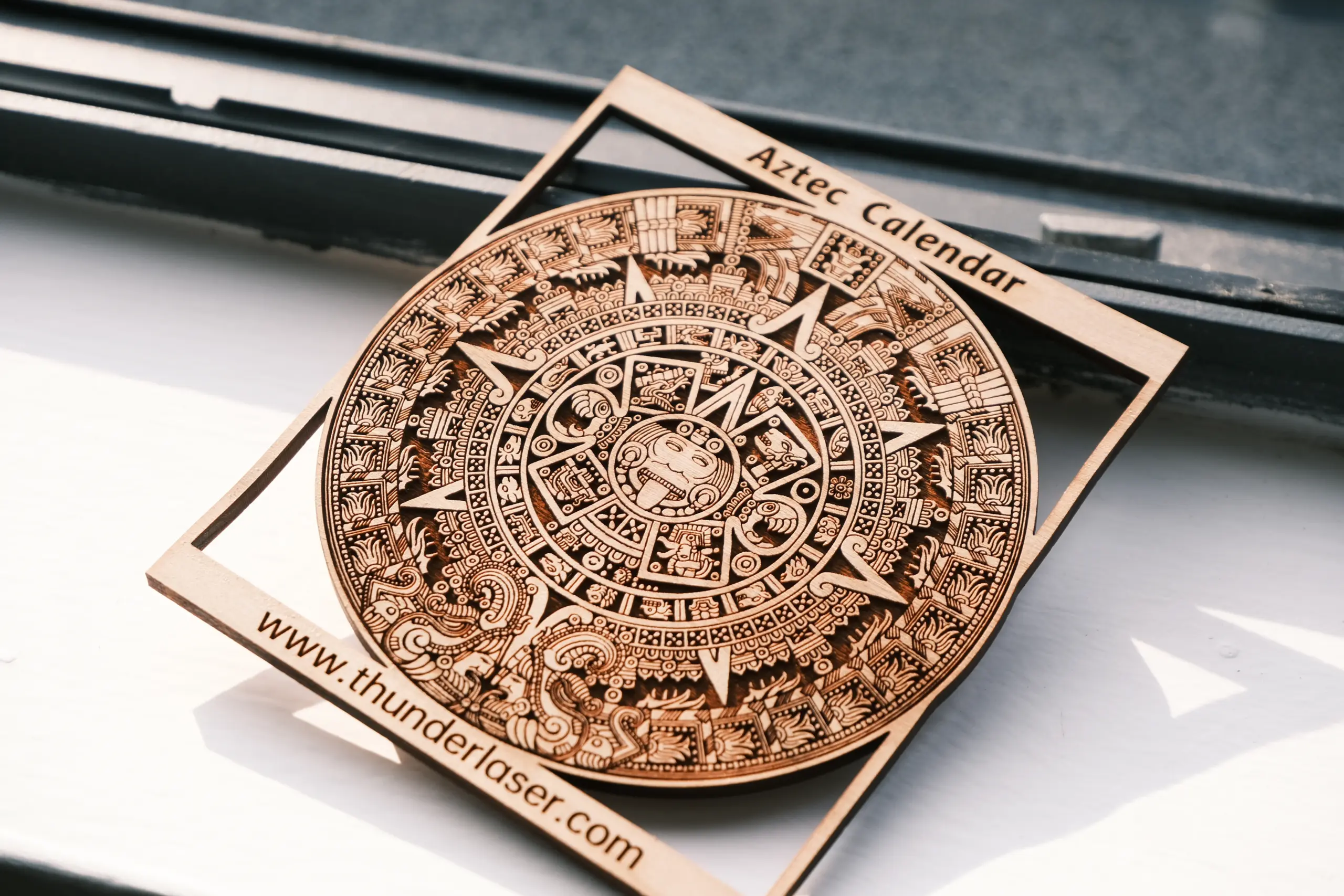 Laser engraved and cut wood with fine engraving detail made with an RF laser tube
