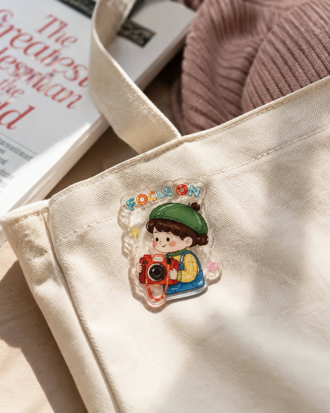 Cute UV printed acrylic character pin attached to a canvas bag