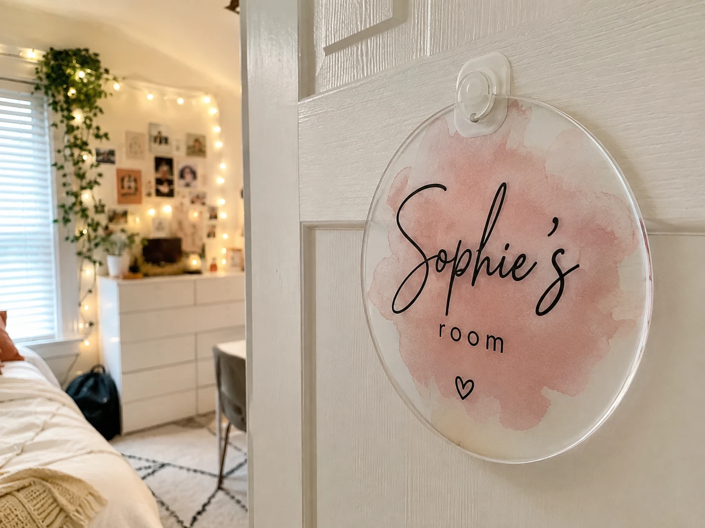Personalized pink UV printed acrylic room sign mounted on a bedroom door