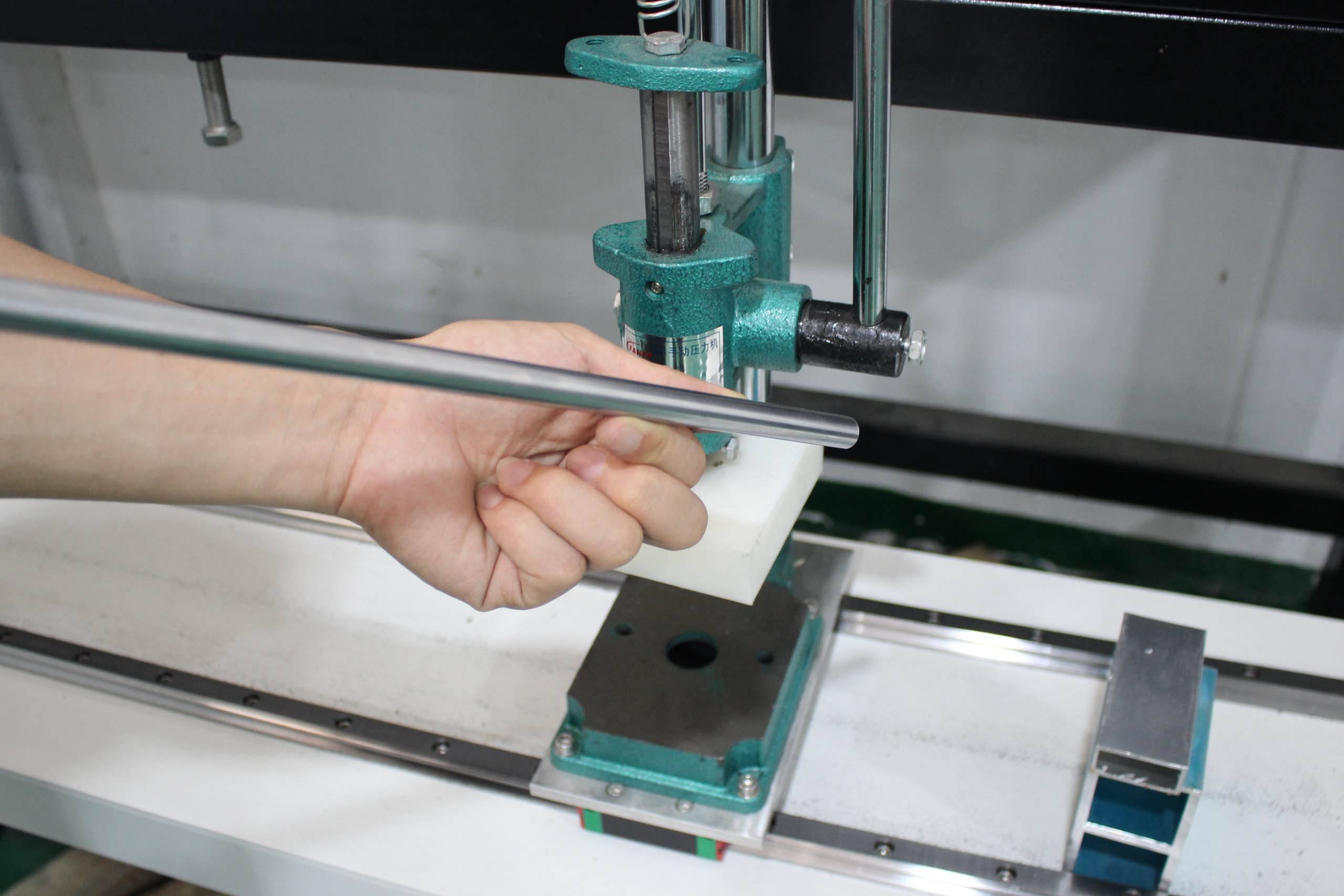 Hand showing the various mechanical parts of the machine