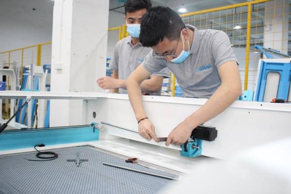 Employee assembling a laser engraving machine