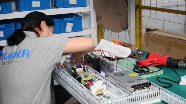 Employee installing a circuit into the system