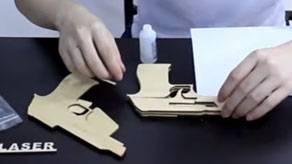 Wooden pieces of 3D printed gun model being assembled