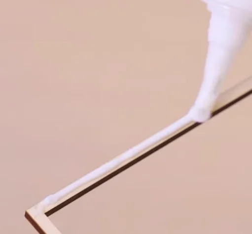 applying glue to layers of maze toy