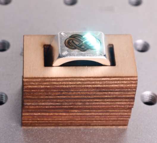 A picture of laser marking a silver ring with thunder aurora lite.