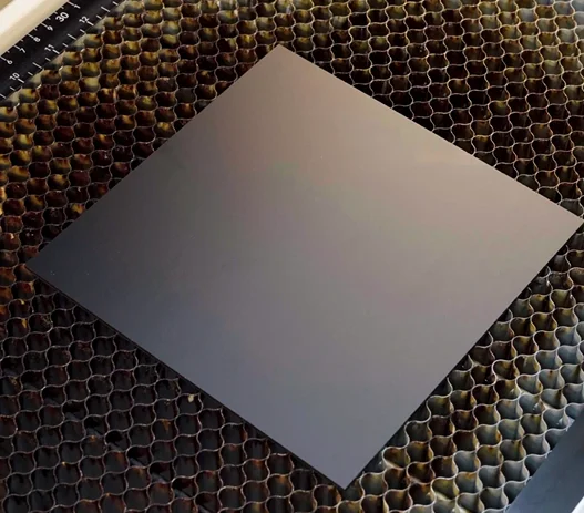 A picture of putting the acrylic onto the work bed.