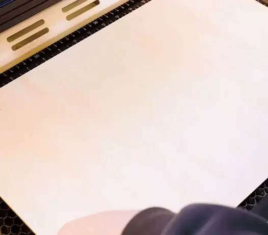 Put the wood onto the work bed