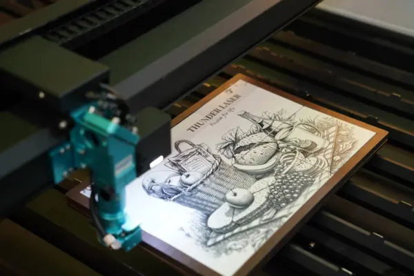 Titan 63 100W RF Tube CO₂ laser machine is engraving a high resolution photo