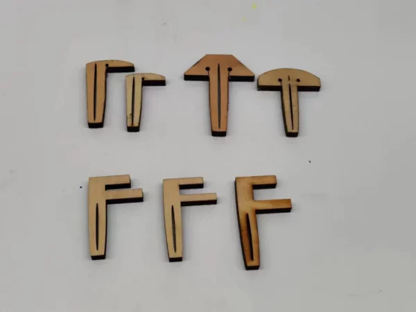 T shaped, L shaped, or F shaped pins used to secure thin materials when cutting and engraving