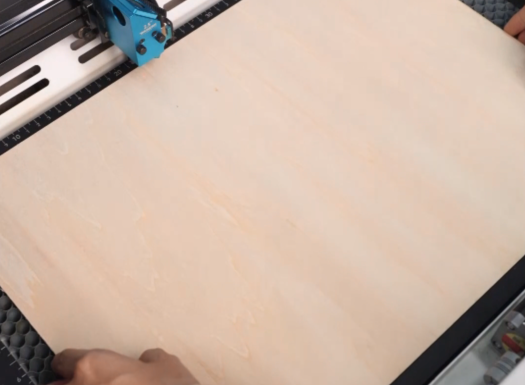 put the wood on the laser bed