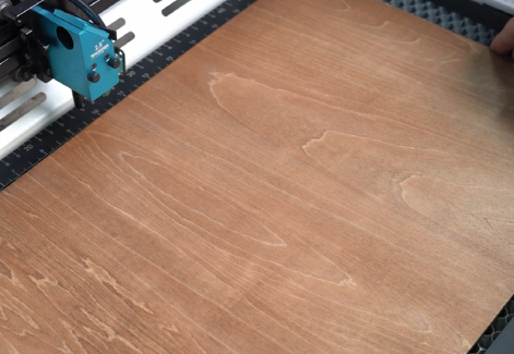 First, put the plywood on the laser bed