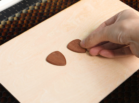 place the guitar picks on the laser bed