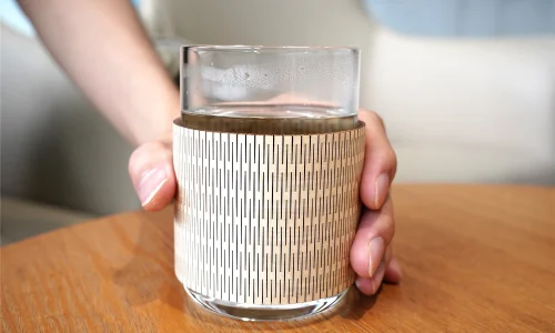 A picture of a laser cut wooden cup sleeve