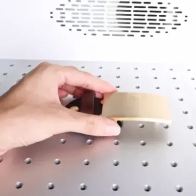 Place the brass belt buckle onto the work bed