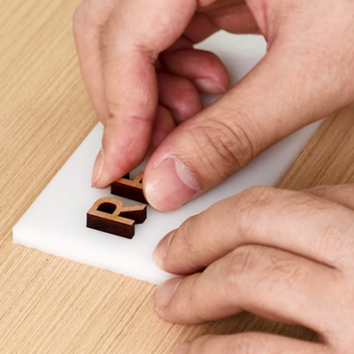 Stick the pieces to the prepared material with glue